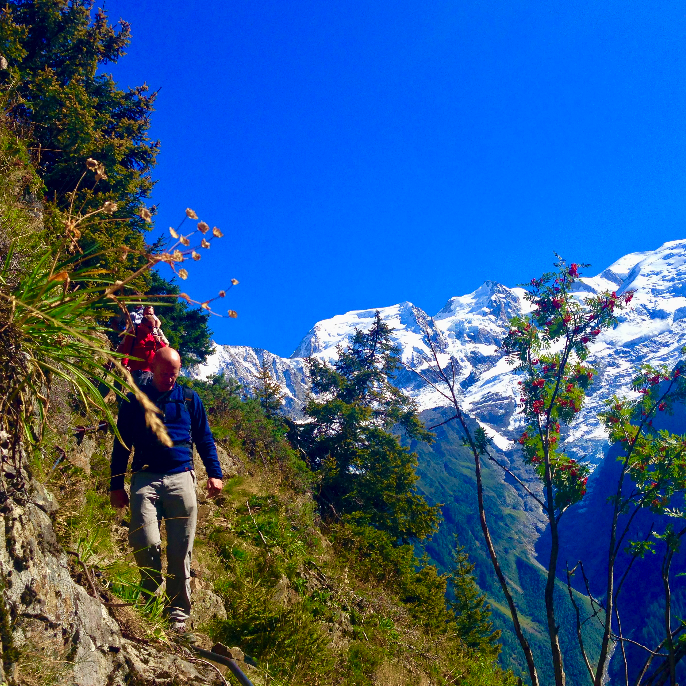 A group hiking a remote trail above the Chamonix valley in Spring